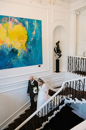 bride-and-groom-holding-hands-on-staircase-of-aston-hall-hotel-at-sheffield-wedding