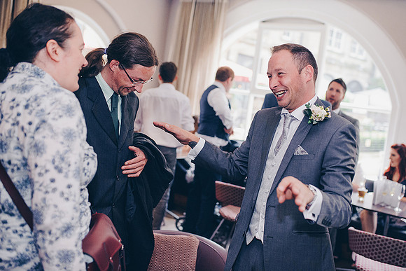 leopold hotel wedding photography groom laughing