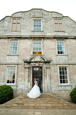 Couple kiss outside Hellaby Hall in Rotherham by wedding photographer Dan Mogan Photography
