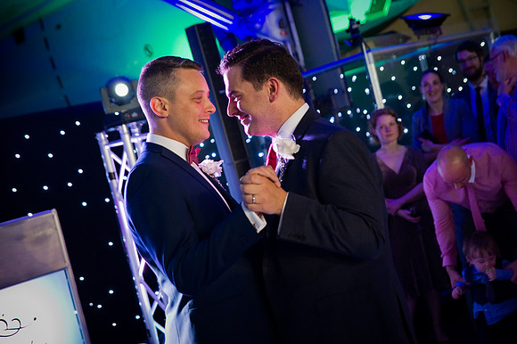 Newly married gay couple dance under Concorde by wedding photographer Dan Mogan Photography