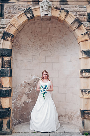 Ringwood hall bride in archway by wedding photographer Dan Mogan Photography