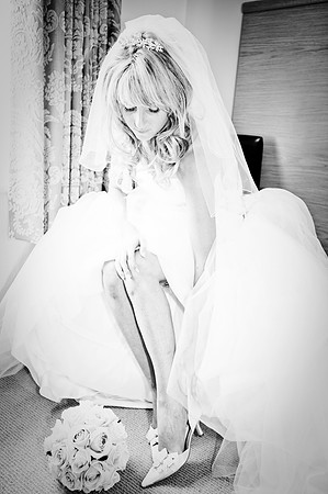 Bride fitting her wedding shoe. photographed by sheffield wedding photographer