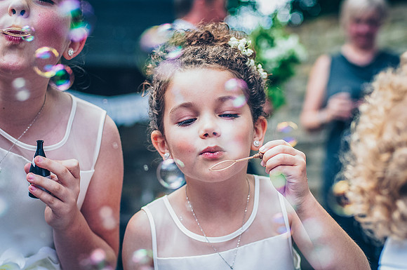 mosborough hall wedding photography of bridesmaid blwoing bubbles