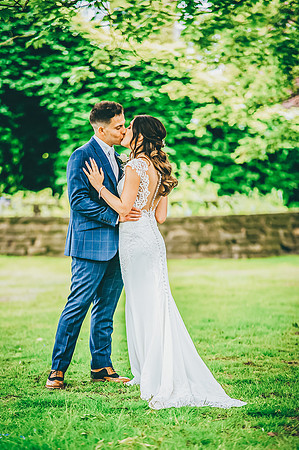 bride and groom kissing in garden of aston hall hotel in sheffield