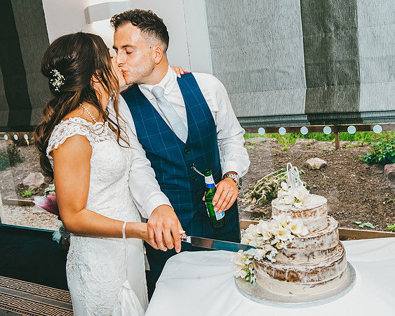 cutting wedding cake at aston hall hotel