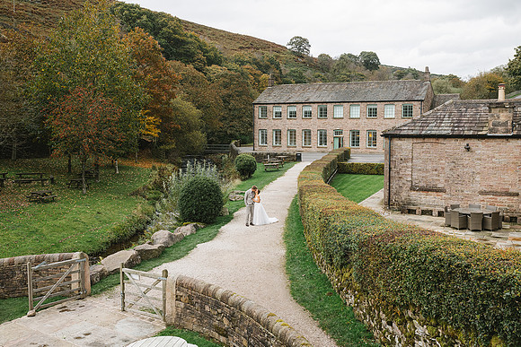 stunning-gradbach-mill-wedding-couple-kissing-landscape