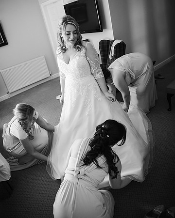 bridemaids frilling out the brides dress at waterton park hotel wedding in west yorkshire