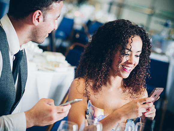 wedding guest checking her phone at manchester wedding