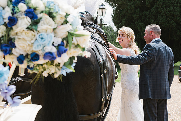 bride-and-groom-candid-wedding-photo-with-horse-and-carraige-at-normanby-hall-scunthorpe