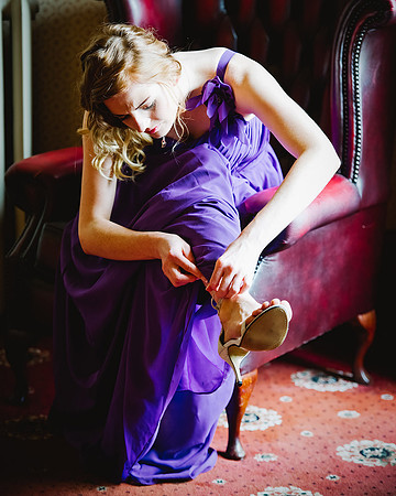 reportage wedding photography of bridesmaid fastening her shoes