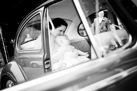 bride and baby in vw beetle wedding car at west yorkshire church